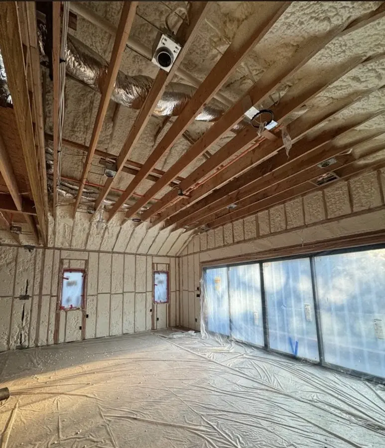 Interior walls and ceiling insulated with spray foam during new construction in Epping